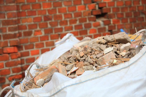 Construction site with waste being cleared by professionals